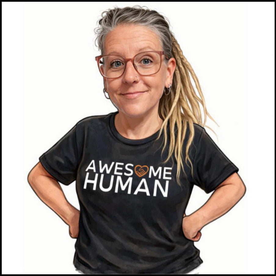 A woman with glasses and blonde dreadlocks wearing a black graphic t-shirt with the text 'AWESOME HUMAN' in white, featuring a small orange heart icon, set against a plain white background.